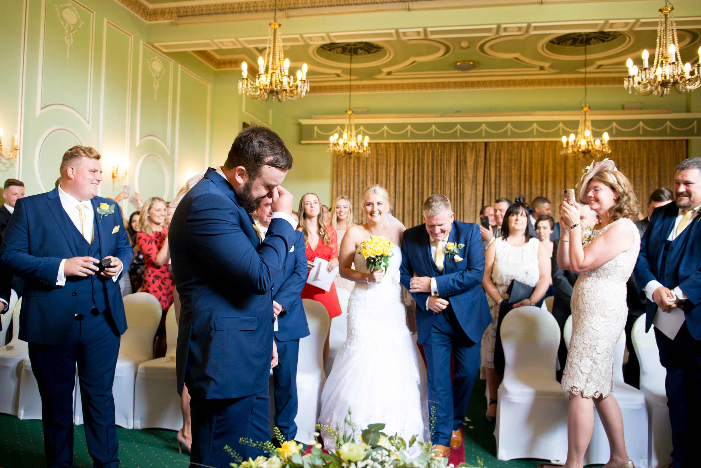 wedding photographer - Bridal entrance and the groom sheds a tear