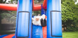 bouncy castle, bride and groom, highgate house hotel, wedding photographer wedding photography northamptonshire