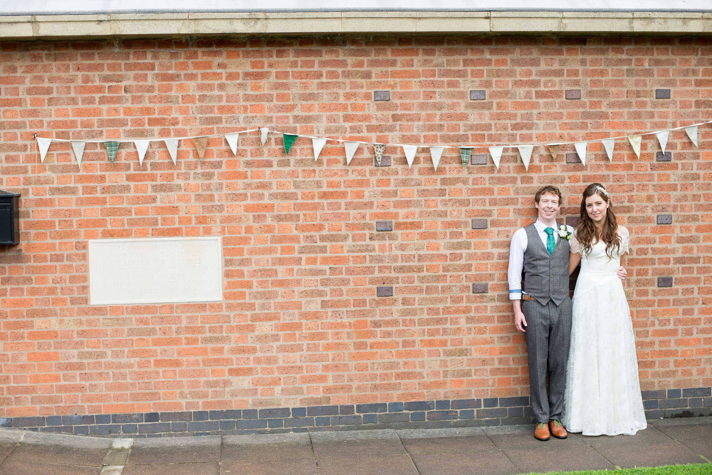 Bride and groom with bunting and bricks