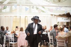 Lincoln Noel - master of ceremony and jazz pianist, wears mother of the brides' hat