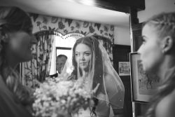 Beautiful bride, veil is down, prepping for the walk down the aisle, wedding photography